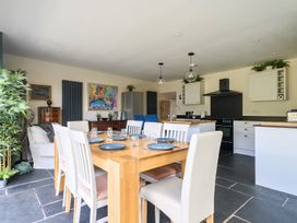 A kitchen with dining table and chairs at The Cottage in Helston