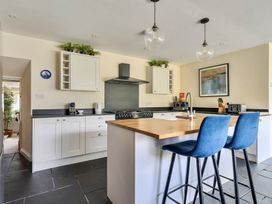 A kitchen with a stove and sink at The Cottage in Helston