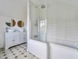 A bathroom with a bathtub and shower at The Cottage in Helston