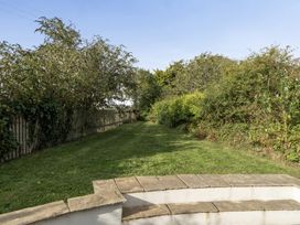 A garden with a pathway and bushes at The Cottage in Helston