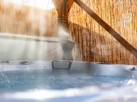 A hot tub with wooden beams and a bamboo screen at 29 Chapel Street Appleby-In-Westmorland
