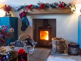 A living room with a fireplace and decorations at 29 Chapel Street Appleby-In-Westmorland