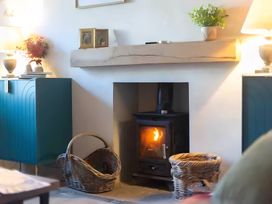 A living room with a fireplace and storage cabinets at 29 Chapel Street Appleby-In-Westmorland