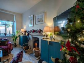 A living room with a fireplace and television at 29 Chapel Street in Appleby-In-Westmorland