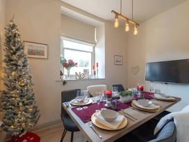 A dining room with a table set for a meal at 29 Chapel Street in Appleby-In-Westmorland