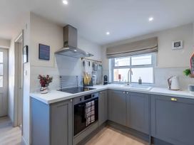 A kitchen with cabinets and appliances at 29 Chapel Street Appleby-In-Westmorland