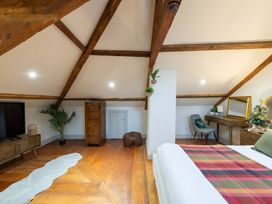 A bedroom with a bed and wooden furniture at 29 Chapel Street in Appleby-In-Westmorland