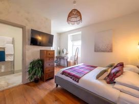 A bedroom with a bed and television at 29 Chapel Street in Appleby-In-Westmorland