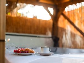 A plate with grapes and a croissant next to a coffee cup in an outdoor seating area at 29 Chapel Street Appleby-In-Westmorland