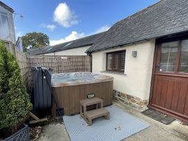 An outdoor area with a hot tub and a step stool at Granary Barn in Winkleigh