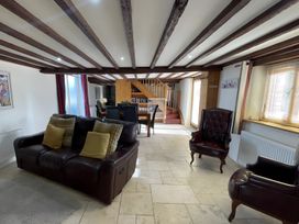 A living room with a sofa and armchair at Granary Barn in Winkleigh