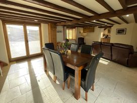 A dining room with a table and chairs at Granary Barn in Winkleigh