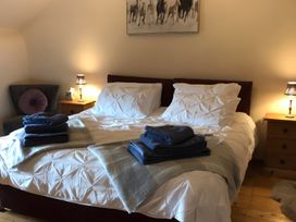 A bedroom with a double bed and nightstands at Granary Barn in Winkleigh