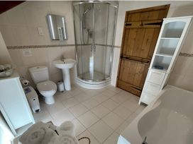 A bathroom with a shower, sink, toilet, and bathtub at Granary Barn in Winkleigh