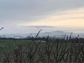 A view of mountains and grass in the foreground at Granary Barn in Winkleigh