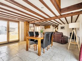 A dining room with a table and chairs at Granary Barn in Winkleigh