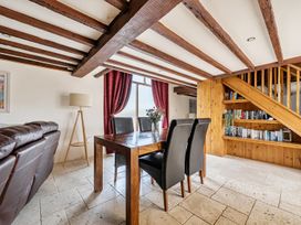 A dining room with a table and chairs at Granary Barn in Winkleigh