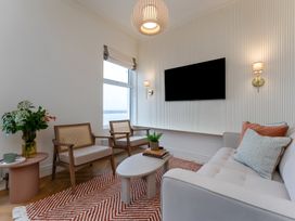 A living room with a sofa and coffee table at Seafront Apartment in Donaghadee
