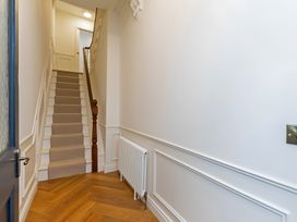 A hallway with stairs and a radiator at Seafront Apartment in Donaghadee