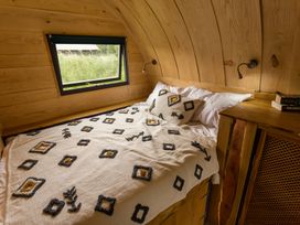 A bedroom with a bed and window at Glamping pod-Luxury Glamping Retreat in Battle