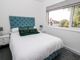 A bedroom with a bed and bedside tables at Tymelyn in Aberystwyth