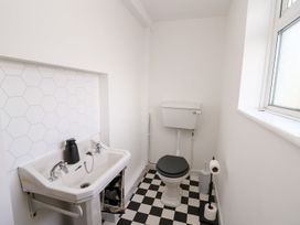 A bathroom with a sink and toilet at Tymelyn in Aberystwyth