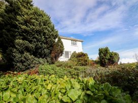 A house with trees and garden greenery at Tymelyn in Aberystwyth