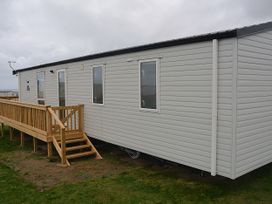 A mobile home with steps and railing at 601 Cribbar Cove, Perranporth
