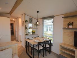 A dining area with table and chairs at 601 Cribbar Cove Perranporth