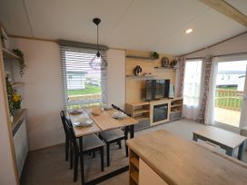 A dining room with a table and chairs at 601 Cribbar Cove Perranporth