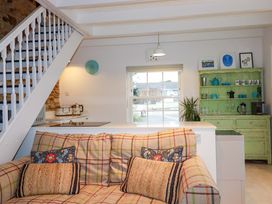 A living room with a sofa and green cabinet at Cubbs Corner in Goonbell near St Agnes