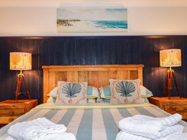A bedroom with a wooden bed and bedside tables at Cubbs Corner in Goonbell near St Agnes