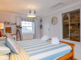 A bedroom with a bed and decorative features at Cubbs Corner in Goonbell near St Agnes