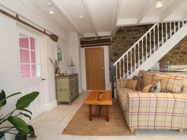 A living room with a sofa and a coffee table at Cubs Corner in St Agnes