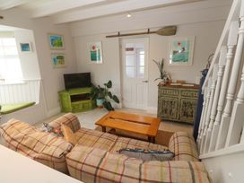 A living room with a sofa and coffee table at Cubs Corner in St Agnes