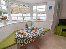 A dining room with a table set for breakfast at Cubs Corner in St Agnes