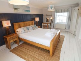 A bedroom with a bed and bedside tables at Cubs Corner in St Agnes