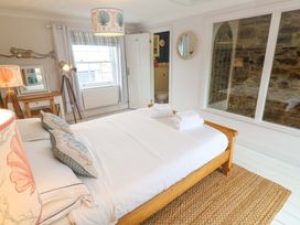 A bedroom with a bed and a window at Cubs Corner in St Agnes