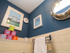 A bathroom with colorful containers and wall art at Cubs Corner St Agnes