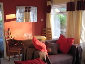 A living room with a table and chairs at Satchwell Chalet Inverness