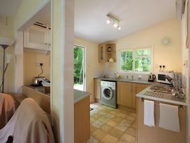 A kitchen with a washing machine and sink at Satchwell Chalet in Inverness