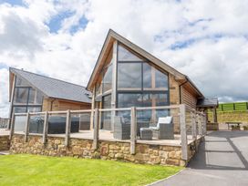 A building with large windows and a deck at Valley View Lodge 1 Preston