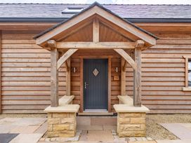 An entrance with a wooden gazebo and stone benches at Valley View Lodge 1 Preston