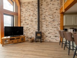 A living room with a television and wood stove at Valley View Lodge 1 Preston