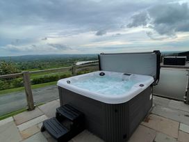 A hot tub on a patio with a view at Valley View Lodge 1 Preston
