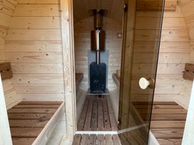 A sauna with wooden benches and a sauna heater at Valley View Lodge 1 in Preston
