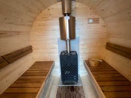 A sauna with wooden benches and a stove at Valley View Lodge 1 Preston