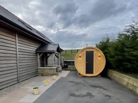 An outdoor area with a barrel sauna and planters at Pendle View in Preston