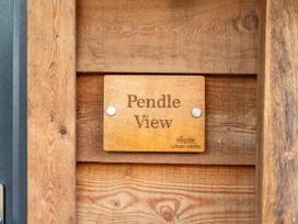 A wooden sign stating Pendle View at Pendle View Preston