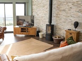 A living room with a television and wood stove at Pendle View Preston